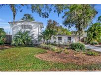 Charming two-story home with landscaped yard and mature trees on a sunny day at 1821 Mohican Trl, Maitland, FL 32751