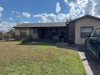 Modest single-story home with a covered front porch and a spacious grassy lawn at 2085 San Jose Blvd, Orlando, FL 32808
