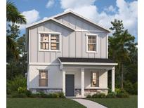 Charming two-story home featuring vertical siding, stone accents, and a welcoming front porch at 5602 Stockade Blvd, St Cloud, FL 34771