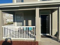 Inviting front porch featuring seating area and black front door at 8989 Lee Vista Blvd # 2106, Orlando, FL 32829