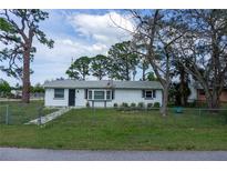 Charming single-story home with a fenced front yard and a fresh white exterior at 1607 India Palm Dr, Edgewater, FL 32132