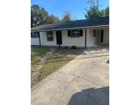 Charming single-story home with a freshly painted exterior and a concrete driveway at 211 Cadillac Ct, Altamonte Springs, FL 32701