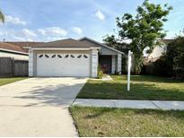Charming single-story home with a well-manicured lawn and attached two-car garage at 4618 Prairie Point, Kissimmee, FL 34746