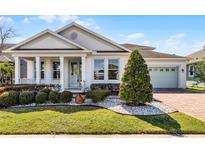 Charming single-story home featuring a well-manicured lawn and lush landscaping, enhancing its curb appeal at 8356 Corkfield Ave, Orlando, FL 32832