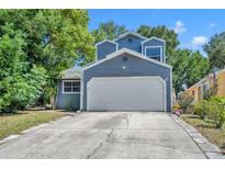 Charming home with a two-car garage and driveway, surrounded by mature trees and landscaping at 119 Winterglen Dr Dr, Sanford, FL 32771