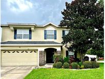 Charming two-story home with a well-manicured lawn and inviting front entrance at 1379 Crane Crest Way, Orlando, FL 32825