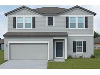 Charming two-story home with gray siding, black shutters and attached two car garage at 1415 Dalkeith Cv, Sanford, FL 32771