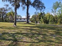 Sprawling lawn in front yard with mature trees offering shade and character at 500 Forest Lake Dr, Altamonte Springs, FL 32714