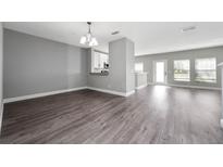 Spacious living room with modern laminate flooring and lots of natural light at 5412 Caramella Dr, Orlando, FL 32829