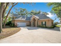 Charming one-story home features a driveway, two-car garage and arched front porch entrance at 5850 Sheryl Anita St, Oviedo, FL 32765