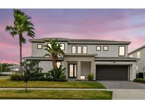 Stunning two-story home showcasing modern architecture and lush landscaping, complete with a palm tree at 3881 Sonoma Blvd, Kissimmee, FL 34741