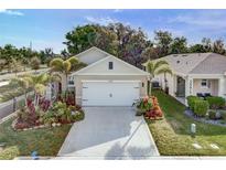 Charming single Gathering home featuring a two car garage, tropical landscaping, and a well maintained lawn at 2271 Delhi Pl, Sanford, FL 32771