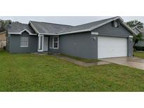 Charming single-story home featuring a well-maintained lawn and attached two-car garage at 236 Bay Head Dr, Kissimmee, FL 34743