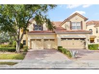 Charming home with a red tile roof, brick driveway, and manicured landscaping, enhancing its curb appeal at 6881 Piazza St, Orlando, FL 32819