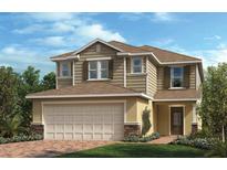 Charming two-story home featuring a two-car garage, classic shutters and a beautifully landscaped front yard at 3269 Rolling Plains Cir, Clermont, FL 34714