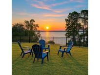 Beautiful backyard seating area overlooking the lake, perfect for relaxing and enjoying scenic views at 3279 Landing Vw, Tavares, FL 32778