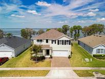 Charming two-story home with landscaped yard and brick paver driveway, near waterfront at 3279 Landing Vw, Tavares, FL 32778