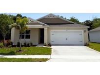 Charming single-story home featuring a well-maintained lawn and a two-car garage at 509 Coronado Cove Rd, New Smyrna Beach, FL 32168