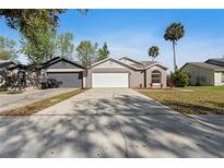 Charming single Gathering home featuring a two-car garage and well-maintained landscaping at 823 Kokomo Cir, Port Orange, FL 32127