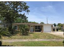 Charming single-story home featuring a well-maintained lawn and attached garage, perfect for a cozy Gathering living at 1612 Furey Dr, Orlando, FL 32822