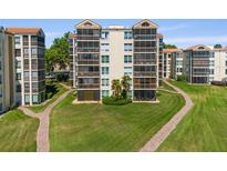 Well-maintained condo building featuring screened patios and lush green landscaping at 204 Quayside Cir # 501, Maitland, FL 32751