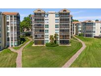 Beautifully landscaped condominium building with screened patios and manicured lawn at 204 Quayside Cir # 501, Maitland, FL 32751