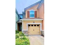 Charming two-story home featuring a one-car garage and manicured landscaping at 2144 Rookery Ln, Sanford, FL 32773