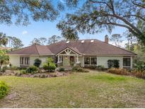 Charming single-story home with a well-manicured lawn and lush landscaping creating excellent curb appeal at 2931 Sunbittern Ct, Windermere, FL 34786