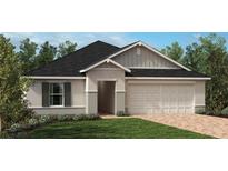 Charming single-story home featuring a brick driveway, manicured lawn, and an attached two-car garage at 3413 Sanctuary Dr, Clermont, FL 34714