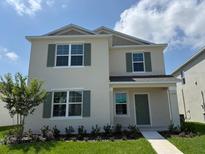 Charming two-story home featuring a manicured lawn, and attractive curb appeal at 5225 Marshelder St, Apopka, FL 32712