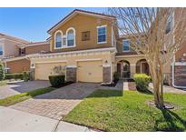 Charming two-story home with a two-car garage and well-manicured lawn on a sunny day at 5373 Via Appia Way, Sanford, FL 32771