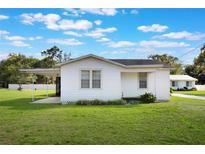 Charming one-story home with a well-maintained lawn and cozy screened-in patio at 5900 Lyle St, Orlando, FL 32807