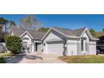 Charming single-story home with well-maintained landscaping and a two-car garage at 5971 Parkview Point Dr, Orlando, FL 32821