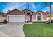 Charming single-Gathering home with a well-manicured lawn, two-car garage, and lovely curb appeal at 611 Saddle Ridge Dr, Davenport, FL 33896
