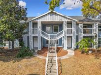 Inviting condo complex with stairs leading to the units and well-maintained landscaping at 2580 Grassy Point Dr # 100, Lake Mary, FL 32746