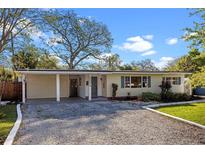 Charming single story home featuring a gravel driveway, covered entryway, and well maintained lawn at 3006 Northwood Blvd, Winter Park, FL 32789