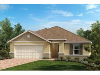 Charming one-story home with a two car garage, manicured lawn, and beautiful landscaping at 3394 Sanctuary Dr, Clermont, FL 34714