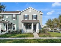 Charming townhome with a welcoming front porch and manicured lawn in a well-maintained community at 502 Rainbow Springs Loop, Groveland, FL 34736