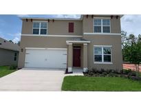 Charming two-story home with a two-car garage, and a well-maintained lawn at 5063 Marshelder St, Apopka, FL 32712
