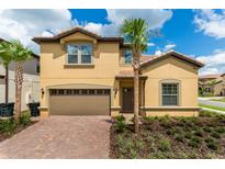 Charming two-story home with a two-car garage, and beautifully landscaped yard at 8801 Rhodes St, Kissimmee, FL 34747