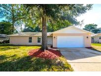 Charming single-story home with mature trees and a well-maintained lawn at 100 Huntswood Ct, Longwood, FL 32750