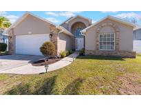 Charming home featuring a blend of stucco and brick accents and a well-manicured front lawn at 3043 Autumn Run Ct, Orlando, FL 32822