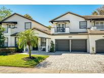 Charming two-story home with a paved driveway, attached garages, and a well-maintained front lawn at 777 S Denning Dr # B, Winter Park, FL 32789