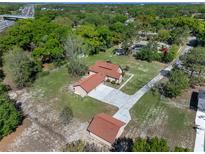 An aerial view showcases this home's lush, green surroundings and charming exterior at 9272 Gotha Rd, Windermere, FL 34786