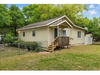 Charming single-story home featuring a cozy front porch, well-maintained lawn, and mature trees at 1401 E Voorhis Ave, Deland, FL 32724