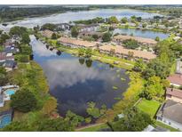 Scenic aerial view of waterfront condos with lush green surroundings and tranquil lake, a perfect community at 1484 Patricia St, Kissimmee, FL 34744