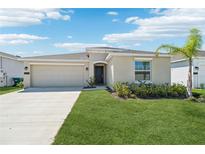 Charming single-story home featuring a well-manicured lawn, two car garage, and lush landscaping at 1533 Peach Creek Dr, Osteen, FL 32764