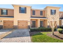 Charming two-story townhome featuring a well-manicured lawn, a one-car garage, and a welcoming front entrance at 1625 Smokey Oak Way, Longwood, FL 32750
