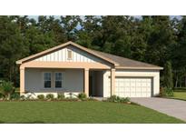 Charming single-story home with neutral colors, a two-car garage, and manicured landscaping at 1667 Meadowlark Dr, Deltona, FL 32725