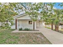 Charming single-story home with a freshly painted white brick exterior and a welcoming carport at 226 Noxon St, Auburndale, FL 33823